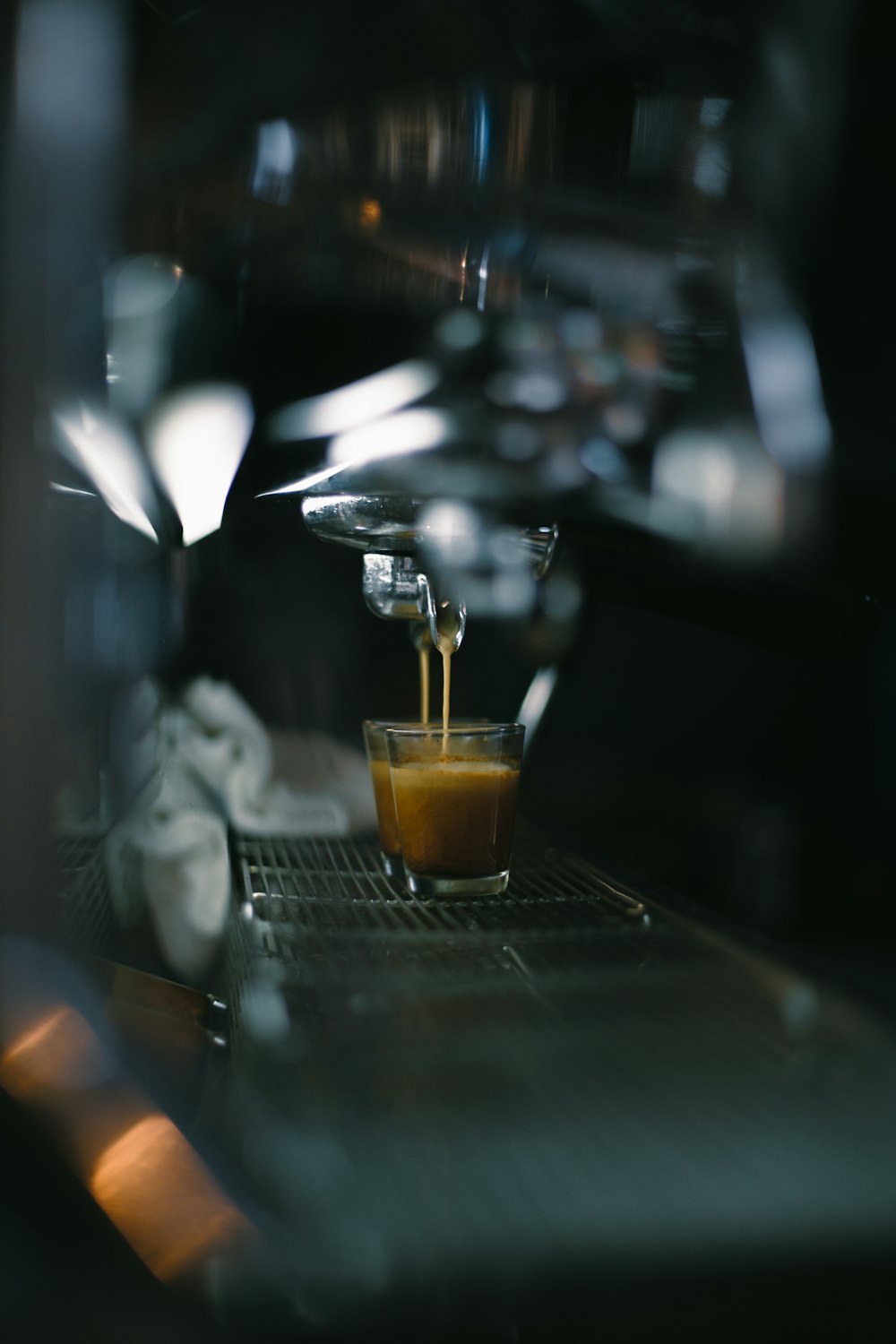 Espresso pouring from a coffee machine into a glass