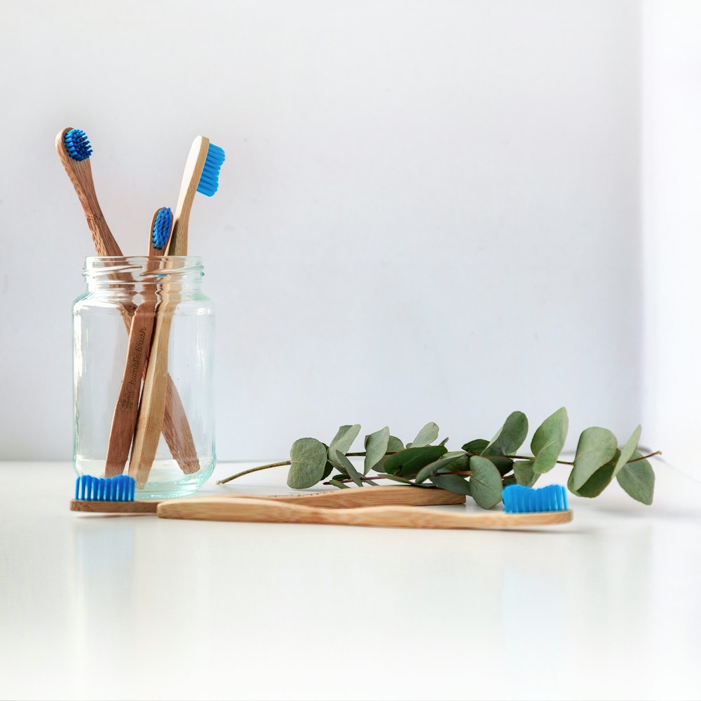 Bamboo toothbrushes standing in a glass jar